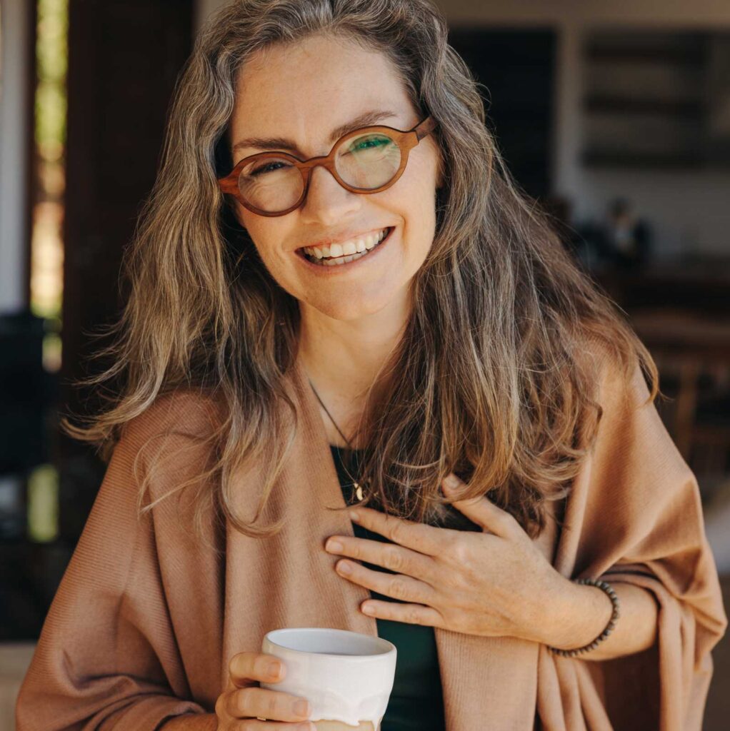 Woman smiling after acupuncture | Acupuncture for Menopause & Perimenopause in Boulder & Longmont