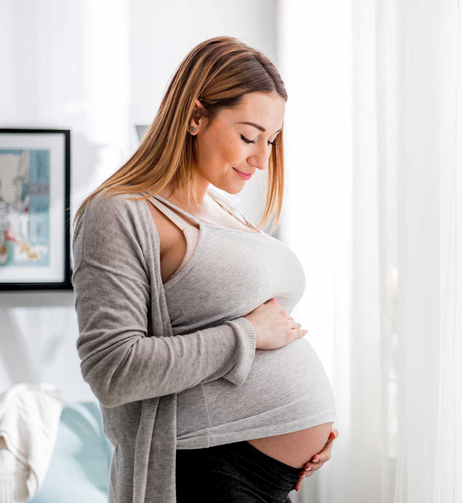 Pregnant woman feeling the baby | Acupuncture for Pregnancy & Postpartum in Boulder & Longmont