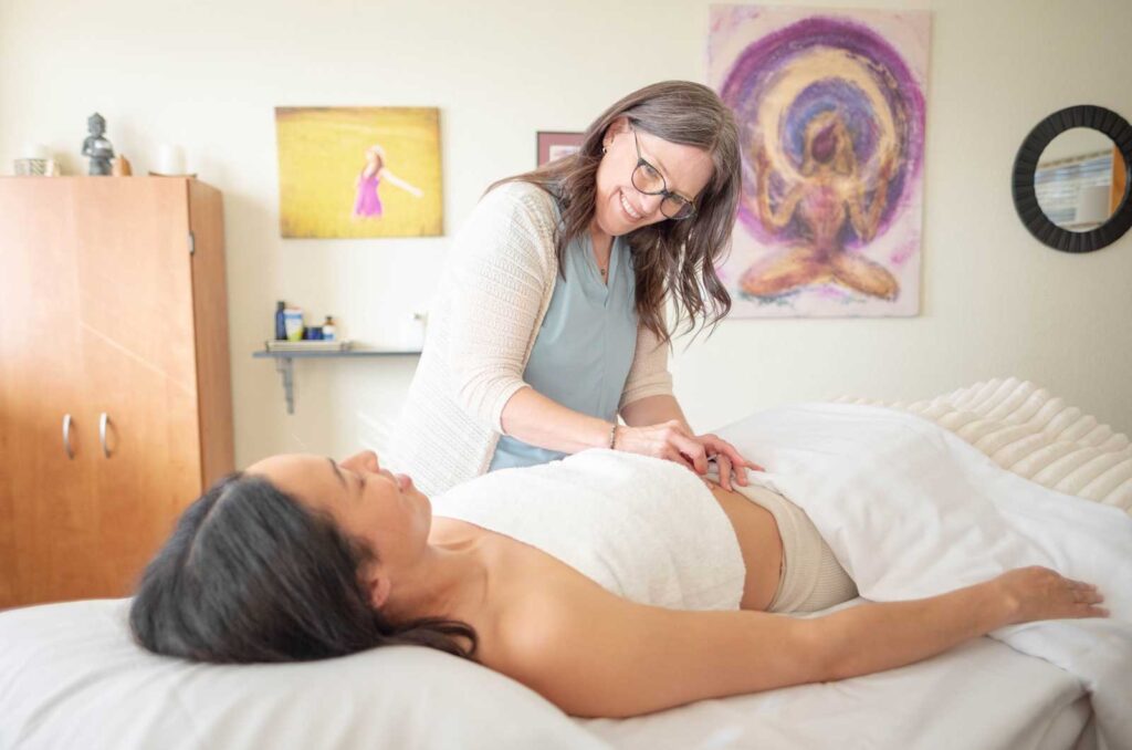 Maren doing acupuncture for IVF patient | IVF Acupuncture | IUI Acupuncture in Boulder & Longmont | Well Woman