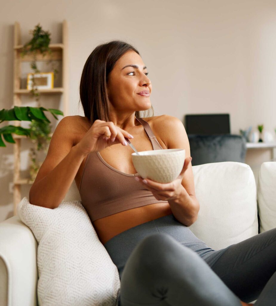 Happy, Fit Woman Smiling while eating healthy | Acupuncture for Digestion & Immune System Support | Well Woman