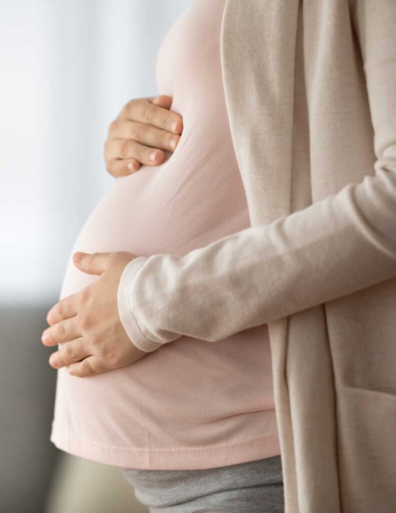 Pregnant woman holding her belly | Acupuncture for Fertility | Boulder Acupuncture for Fertility | Longmont
