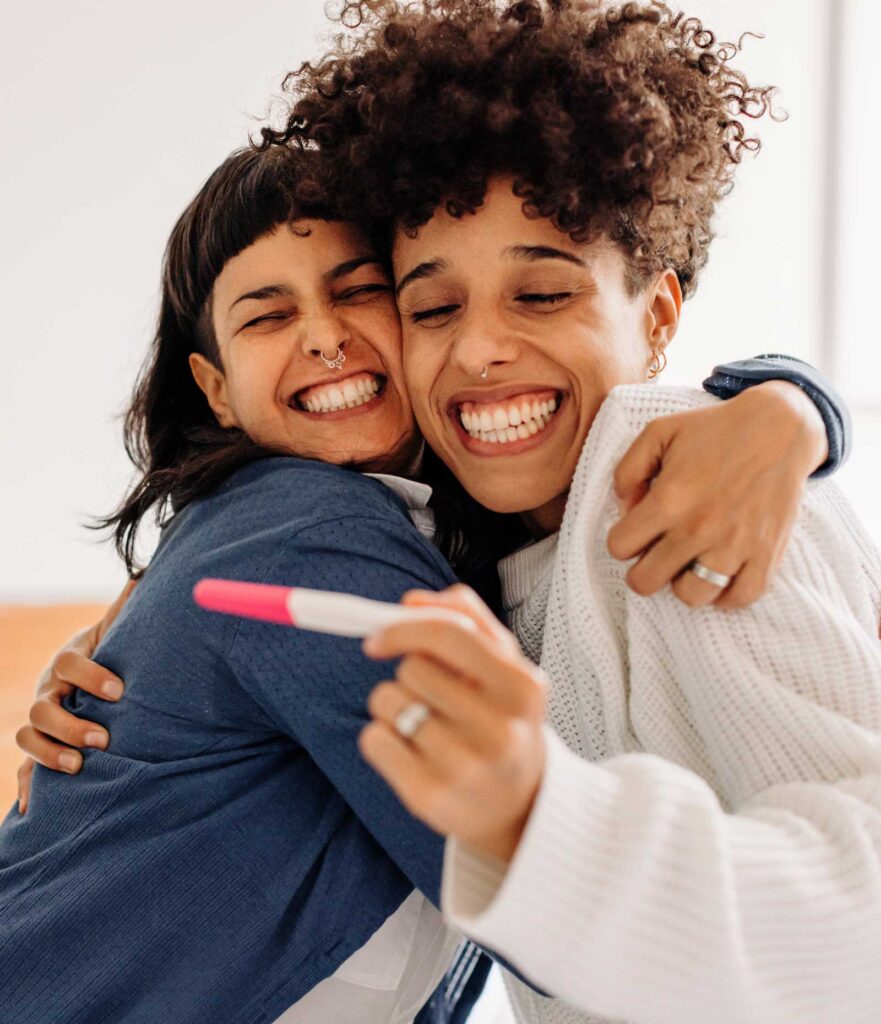 Lesbian couple with a positive test for pregnancy | IVF Acupuncture | IUI Acupuncture in Boulder & Longmont | Well Woman