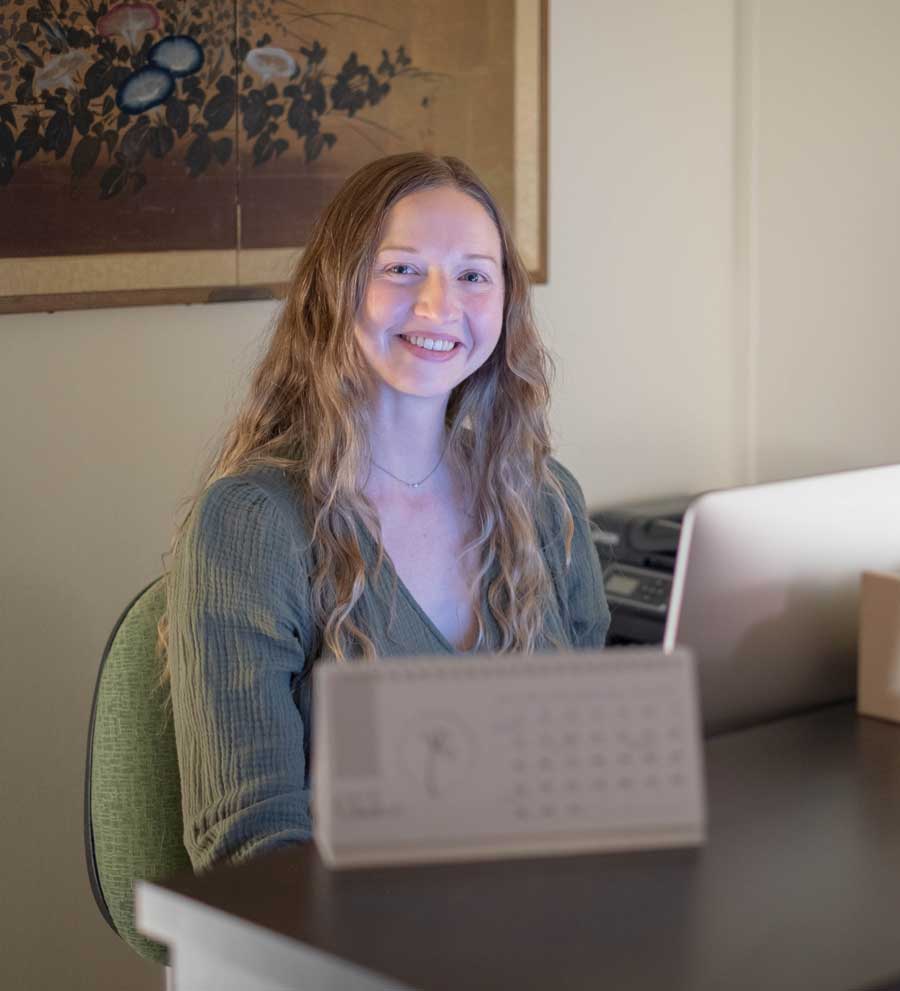 Happy female receptionist smiling | Contact Well Woman Acupuncture in Boulder & Longmont, CO