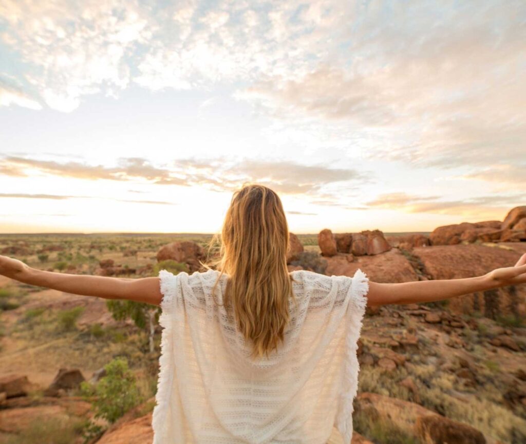 Women extending her arms while viewing the sunrise | Women's Health Acupuncture in Boulder & Longmont | Well Woman Acupuncture