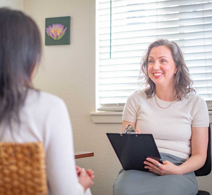 Woman smiling during your first acupuncture visit | First Acupuncture Visit: What to Expect at First Acupuncture Appointment