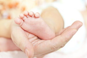 hand and baby foot | Pathway to Pregnancy, Part III: Postpartum & the 4th Trimester